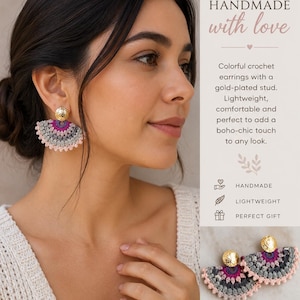 May include: Fan-shaped crochet earrings featuring a textured gold-plated stud and a multi-colored semi-circular design in shades of pink, purple, and grey. The earrings display a detailed stitched pattern and are presented with text overlays.