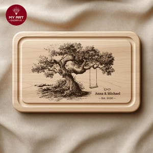 May include: A rectangular wooden chopping board featuring an engraved tree with a swing. The text "Anna & Michael - Est. 2026 -" is below the tree. The board has a rounded edge.