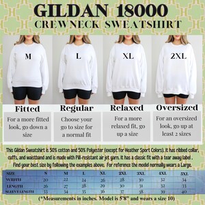 May include: White Gildan 18000 crewneck sweatshirt with size guide. The image shows models wearing different sizes, from M to 2XL, with size chart details. The text provides fitting advice: fitted, regular, relaxed, and oversized.