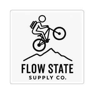 May include: A white sticker featuring a black line drawing of a person riding a mountain bike over a mountain range. The text "FLOW STATE SUPPLY CO." is below the illustration.