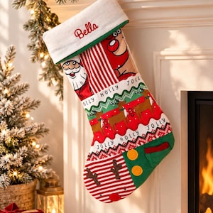 May include: A Christmas stocking with a white cuff embroidered with the name Bella in red. The stocking features a patchwork design with a Santa Claus illustration, red and white stripes, reindeer motifs, and the text Jolly Holly printed on the fabric.