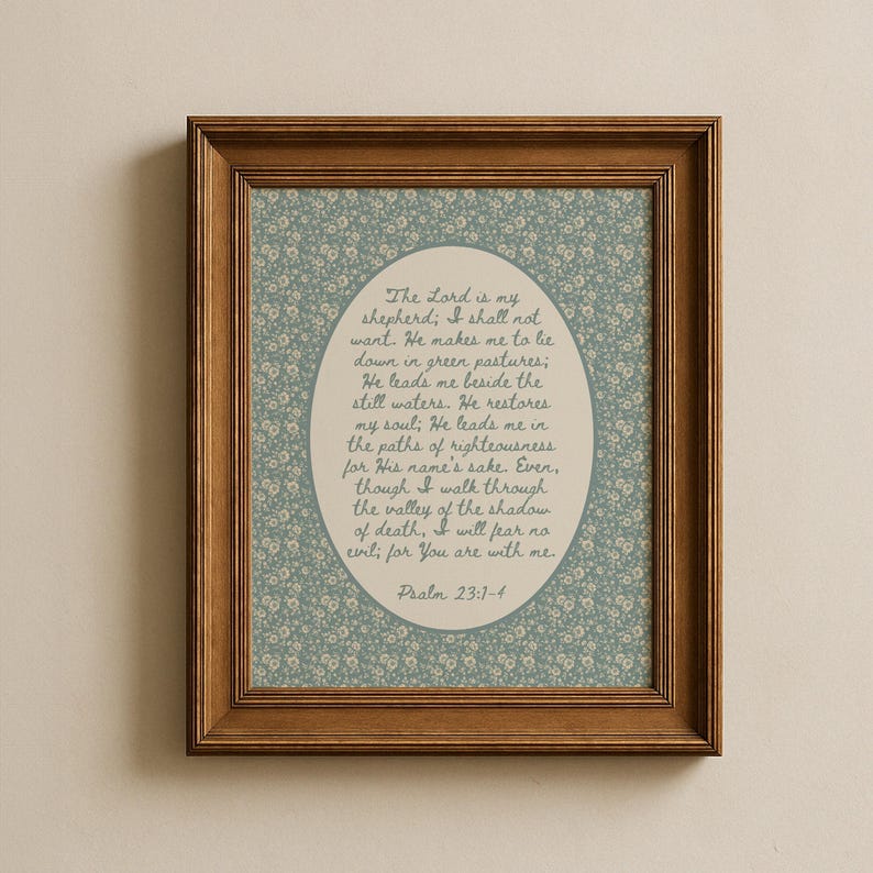 May include: A framed print featuring a floral patterned background in shades of blue and white. The print has a wooden frame. The text within the frame reads "The Lord is my shepherd; I shall not want...Psalm 23:1-4."