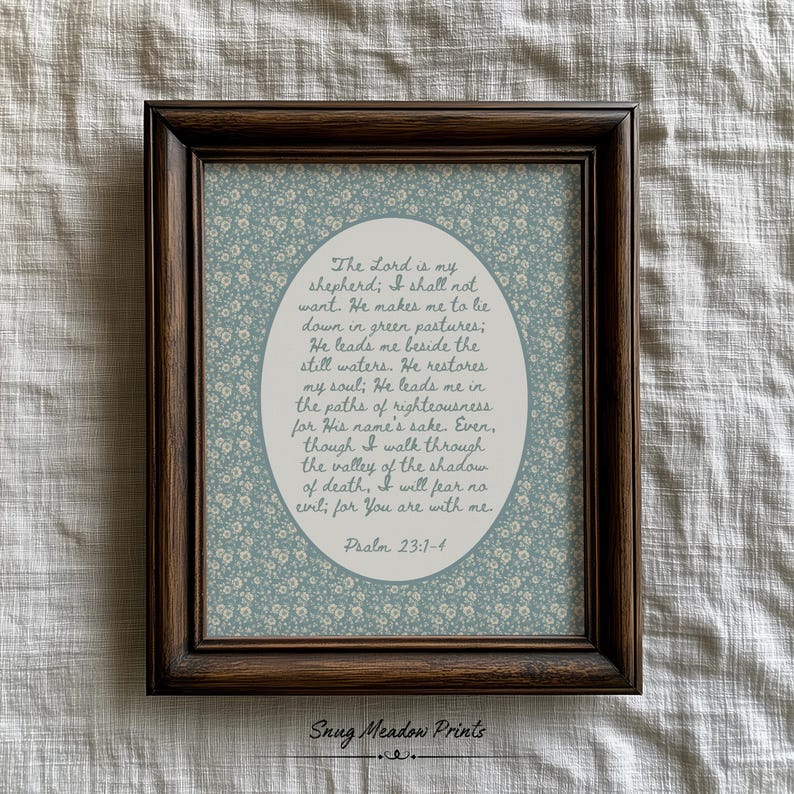 May include: A framed print featuring a floral patterned background in shades of blue and white. The print contains an oval-shaped text box with a religious quote from Psalm 23:1-4. The frame is a dark brown color.