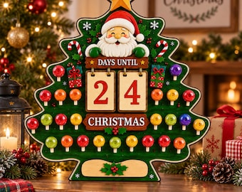 May include: A green Christmas tree-shaped countdown calendar featuring a smiling Santa Claus at the top, a yellow star, and two flip-style wooden panels displaying the number 24. The text reads DAYS UNTIL CHRISTMAS, with colourful round ornaments.
