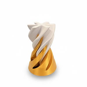 May include: A modern, abstract sculpture with a swirling design. The sculpture features a combination of white and gold colors, creating a visually striking piece. The base is gold, transitioning to white at the top.