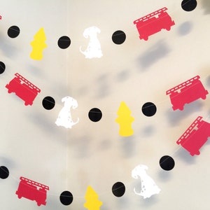 May include: A red, white and black paper garland with fire engine, dalmatian dog and fire hydrant cut-outs. The garland is strung together with black circles.