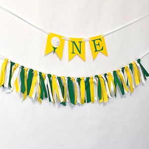May include: A yellow and green banner with the word 