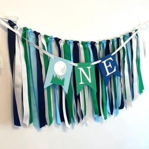 May include: A blue, green, and white banner with the word 