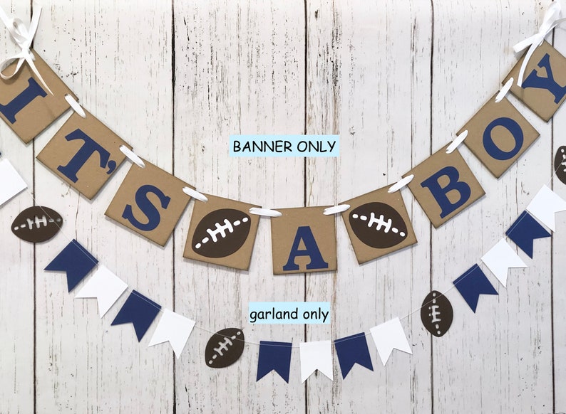 May include: It's a boy banner with brown paper squares with blue letters and footballs. A matching garland with blue and white pennants and footballs.