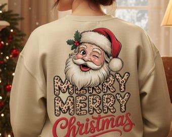 May include: Beige sweatshirt featuring a winking Santa Claus graphic wearing a red hat. The words "MERRY MERRY Christmas" are printed in a combination of leopard print and red script, perfect for the holiday season.