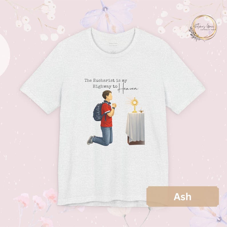 Unisex Bella and Canvas Catholic t-shirt featuring Saint Carlo Acutis kneeling in Eucharistic Adoration with the quote “The Eucharist is my Highway to Heaven,” Christian faith apparel for men and women. Perfect for Catholic gifts.