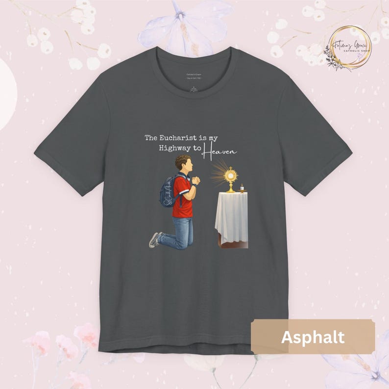 Unisex Bella and Canvas Catholic t-shirt featuring Saint Carlo Acutis kneeling in Eucharistic Adoration with the quote “The Eucharist is my Highway to Heaven,” Christian faith apparel for men and women. Perfect for Catholic gifts.