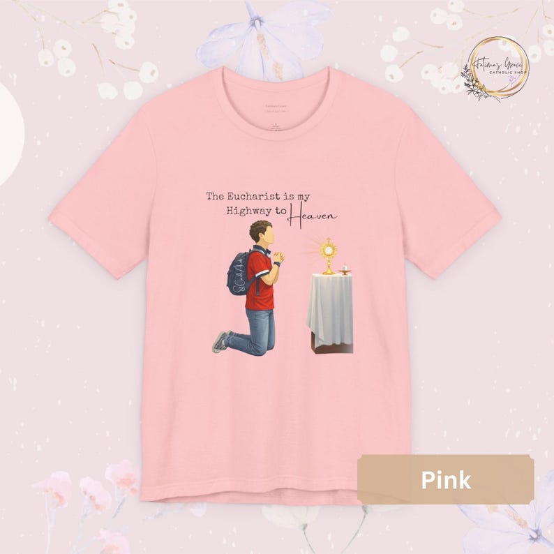 Unisex Bella and Canvas Catholic t-shirt featuring Saint Carlo Acutis kneeling in Eucharistic Adoration with the quote “The Eucharist is my Highway to Heaven,” Christian faith apparel for men and women. Perfect for Catholic gifts.