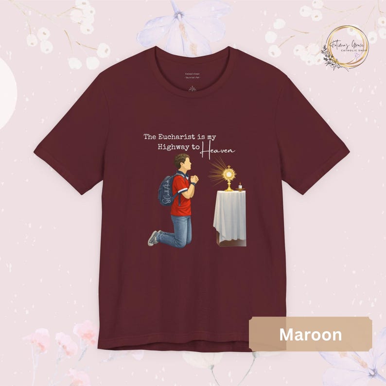 Unisex Bella and Canvas Catholic t-shirt featuring Saint Carlo Acutis kneeling in Eucharistic Adoration with the quote “The Eucharist is my Highway to Heaven,” Christian faith apparel for men and women. Perfect for Catholic gifts.
