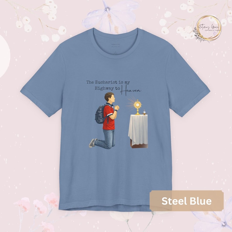 Unisex Bella and Canvas Catholic t-shirt featuring Saint Carlo Acutis kneeling in Eucharistic Adoration with the quote “The Eucharist is my Highway to Heaven,” Christian faith apparel for men and women. Perfect for Catholic gifts.