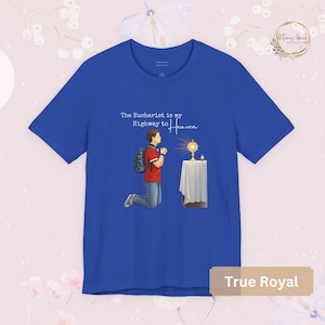 Unisex Bella and Canvas Catholic t-shirt featuring Saint Carlo Acutis kneeling in Eucharistic Adoration with the quote “The Eucharist is my Highway to Heaven,” Christian faith apparel for men and women. Perfect for Catholic gifts.