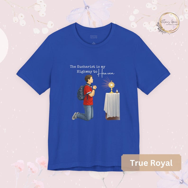 Unisex Bella and Canvas Catholic t-shirt featuring Saint Carlo Acutis kneeling in Eucharistic Adoration with the quote “The Eucharist is my Highway to Heaven,” Christian faith apparel for men and women. Perfect for Catholic gifts.