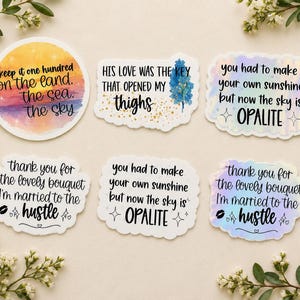 May include: Six decorative stickers with various designs. One circular sticker features a sunset gradient with text. Five die-cut stickers feature black text on white or holographic backgrounds, including phrases like 'His love was the key that opened my thighs'.