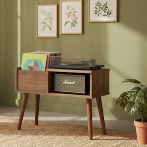 May include: A wooden record player console with four tapered legs, featuring a storage compartment for vinyl records on the left and a shelf containing a black Marshall speaker on the right, with a turntable placed on the top surface.