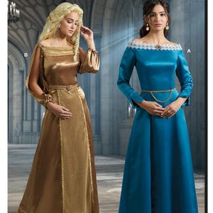 May include: McCall's Costumes pattern featuring two medieval-style dresses. One dress is gold with long sleeves, and the other is teal with a white lace trim. The pattern is designed and printed in the USA.