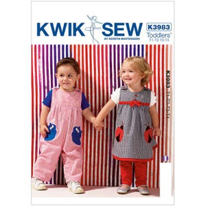 May include: Kwik Sew K3983 sewing pattern for toddlers, sizes T1-T4. The cover features two children wearing outfits: one in pink and white striped overalls with blue creature appliques, and one in a black and white gingham dress with red ladybug appliques and red pants.