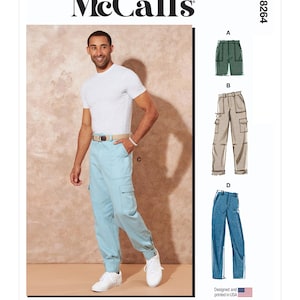 May include: McCall's sewing pattern featuring multiple views of cargo pants and shorts. The image shows a person wearing light blue cargo pants. The pattern includes options for green shorts, tan cargo pants, and blue jeans. The text reads "Designed and printed in USA."