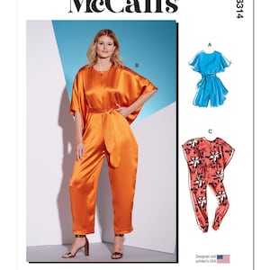 May include: McCall's sewing pattern M8314 features a woman wearing an orange satin jumpsuit with a matching belt. The pattern also includes a blue romper and a floral jumpsuit design. The text "Designed and printed in USA" is visible.