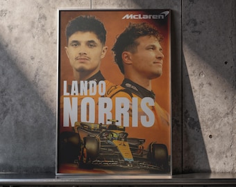 May include: Framed poster featuring Lando Norris, a Formula 1 driver, with a McLaren race car. The poster has an orange and black color scheme, with the McLaren logo at the top. The name "Lando Norris" is prominently displayed.