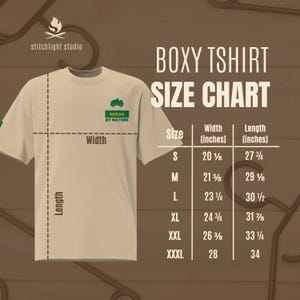 May include: A beige boxy t-shirt with the text "NOMAD BY NATURE" and a size chart. The chart shows measurements in inches for sizes S to XXXL, including width and length.