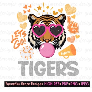 May include: A graphic illustration of a tiger wearing pink heart-shaped sunglasses and blowing a pink bubblegum bubble. The design includes orange hearts, stars, a foam finger with #1, a megaphone labeled tigers, and the text LETS GO! TIGERS.