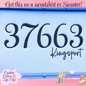 May include: A light blue fabric featuring dark navy blue embroidery of the number 37663 and the word Kingsport. The text at the top reads Get this on a sweatshirt or Sweater! and the bottom left text reads Custom Colors & Zip, City!