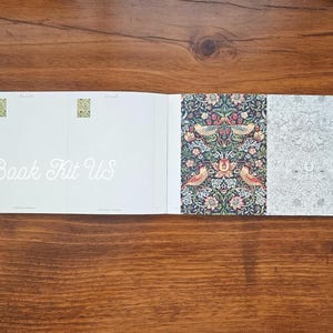 May include: An open book kit with the text "Book Kit Us" in cursive. The book's pages display a variety of patterns, including floral designs with birds and intricate, repeating patterns in shades of green, red, and white.