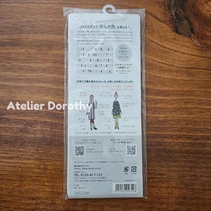 May include: A clear plastic package with Japanese text and illustrations. The package features a variety of sewing stitch diagrams and two illustrated figures. The text includes the words "100 Neesan" and "Atelier Dorothy".