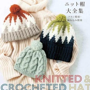May include: A book cover titled "KNITTED & CROCHETED HAT" featuring three knit hats with pom-poms: one with a rust, white, and gray mountain pattern, one with a green, white, and dark blue mountain pattern, and one solid light green cable knit hat.