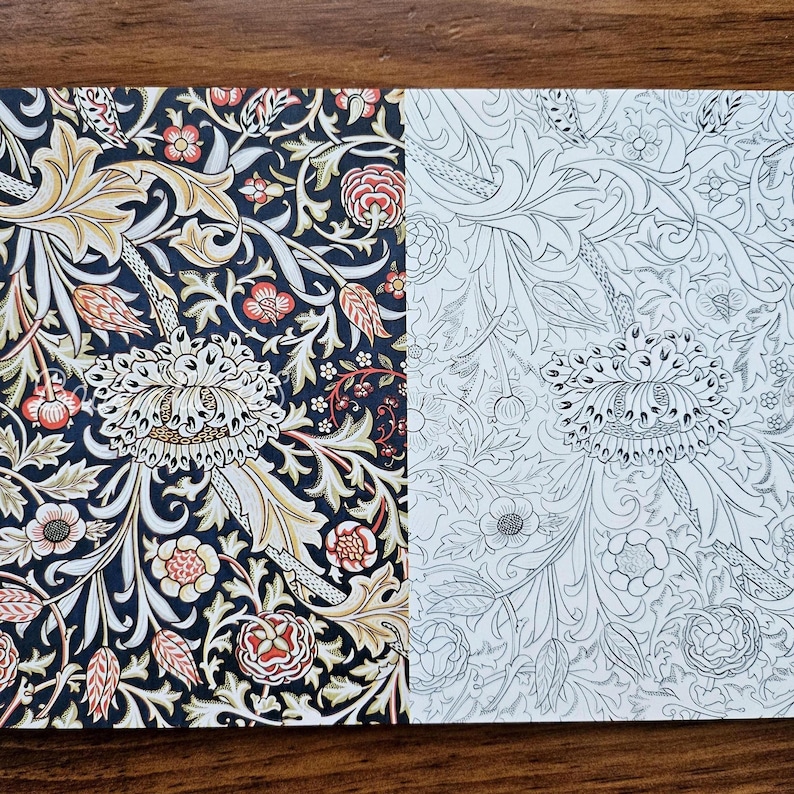 May include: Two floral patterned papers. One features a dark navy background with cream, gold, red, and peach-colored flowers and leaves. The other is a black and white line drawing of the same floral pattern.
