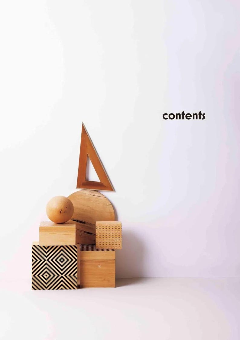 Puede incluir: Una composici&oacute;n de naturaleza muerta con formas geom&eacute;tricas de madera. Un tri&aacute;ngulo de madera, un semic&iacute;rculo, una esfera y varios cubos est&aacute;n dispuestos. Un cubo tiene un patr&oacute;n geom&eacute;trico en blanco y negro. La palabra "contents" est&aacute; escrita en negro.