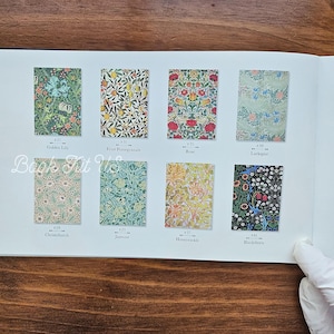 May include: A page from a book featuring eight different floral pattern designs. The patterns include Golden Lily, Fruit Pomegranate, Rose, Larkspur, Christchurch, Jasmine, Honeysuckle, and Blackthorn. The book's title is "Book Tut Us".