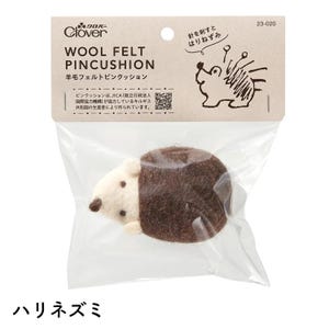 May include: A wool felt pincushion shaped like a hedgehog, packaged in a clear plastic bag. The pincushion is brown and cream-colored, with the text "WOOL FELT PINCUSHION" and Japanese text on the packaging. The Clover logo is visible.