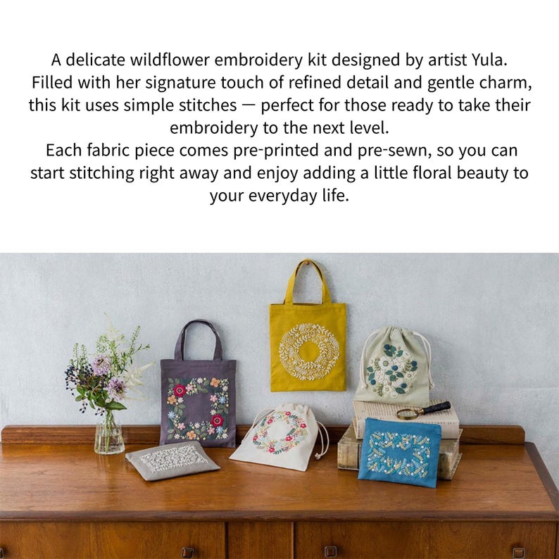 May include: A collection of embroidery kits featuring floral designs. The kits include tote bags, drawstring bags, and small pouches, all adorned with colorful embroidered flowers. The items are displayed on a wooden surface.