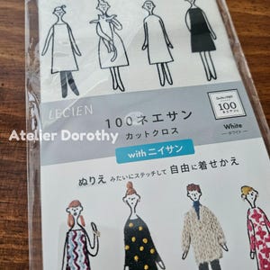 May include: A package of white fabric with a printed design of stylized figures in various outfits. The package includes text in Japanese and English, including "LECIEN" and "Atelier Dorothy." The fabric is designed for stitching.