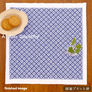May include: White square cloth with a blue geometric pattern. A small plate with two crackers sits on the cloth. A small glass vase with green leaves is also on the cloth. The words "finished image" are at the bottom.