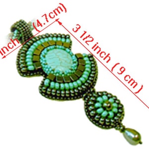 May include: A turquoise and silver beaded pendant with a white stone center. The pendant is 1 7/8 inches long and 3 1/2 inches wide.