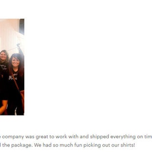 May include: A group of people wearing black t-shirts with white text that says "We're all about the Crazy". The shirts are personalized with different numbers. The group is standing in front of a white wall with colorful balloons.