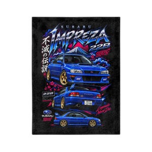 May include: A black graphic print featuring three blue Subaru Impreza 22B STI cars. The design includes the text Subaru Impreza 22B STI, Japanese characters, a mountain silhouette, pink cherry blossoms, and the Subaru logo on a dark background.