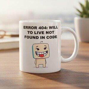 May include: White ceramic mug with a humorous design. The mug features the text "ERROR 404: WILL TO LIVE NOT FOUND IN CODE" above a cartoon character with a smiling face and a red tongue. The mug has a curved handle.