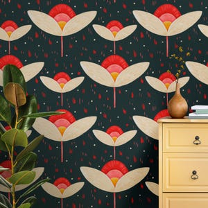 May include: Floral wallpaper with a repeating pattern of stylized flowers in cream, red, and yellow against a dark teal background. The flowers have a mid-century modern aesthetic. A yellow dresser and a potted plant are in the foreground.