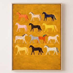 May include: A framed rectangular wall art print featuring a mustard yellow background with twelve stylized horses arranged in four rows. The horses are depicted in various solid colors and patterns, including orange, spotted, black, yellow, pink, and white.