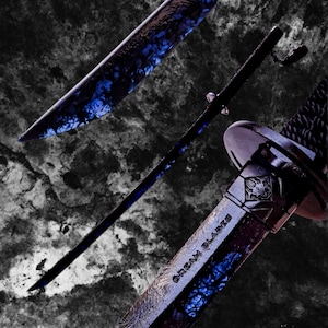 May include: A black katana with a blue and black patterned blade and scabbard. The blade has a unique design with blue accents. The scabbard features the text "DREAM BLADES". The handle is wrapped in black material.