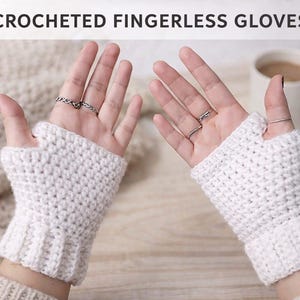 May include: White crocheted fingerless gloves are displayed on hands, showcasing the textured knit. The gloves have a ribbed cuff and a hole for the thumb. The image includes the text "CROCHETED FINGERLESS GLOVES".