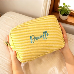 May include: A set of three ceramic mugs with a speckled, matte finish. The mugs are in shades of cream, light gray, and dark gray. Each mug has a simple, minimalist design, perfect for coffee or tea.